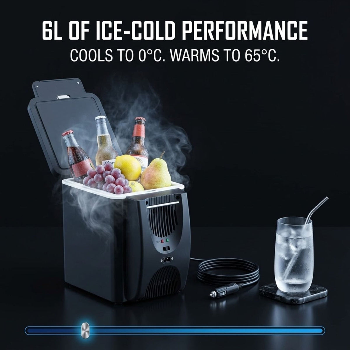 A black portable cooler with its lid open, shown with ice, fruit, and beverage bottles, alongside a glass of iced water and a power cable on a dark background. Text at the top reads '6L OF ICE-COLD PERFORMANCE COOLS TO 0°C.