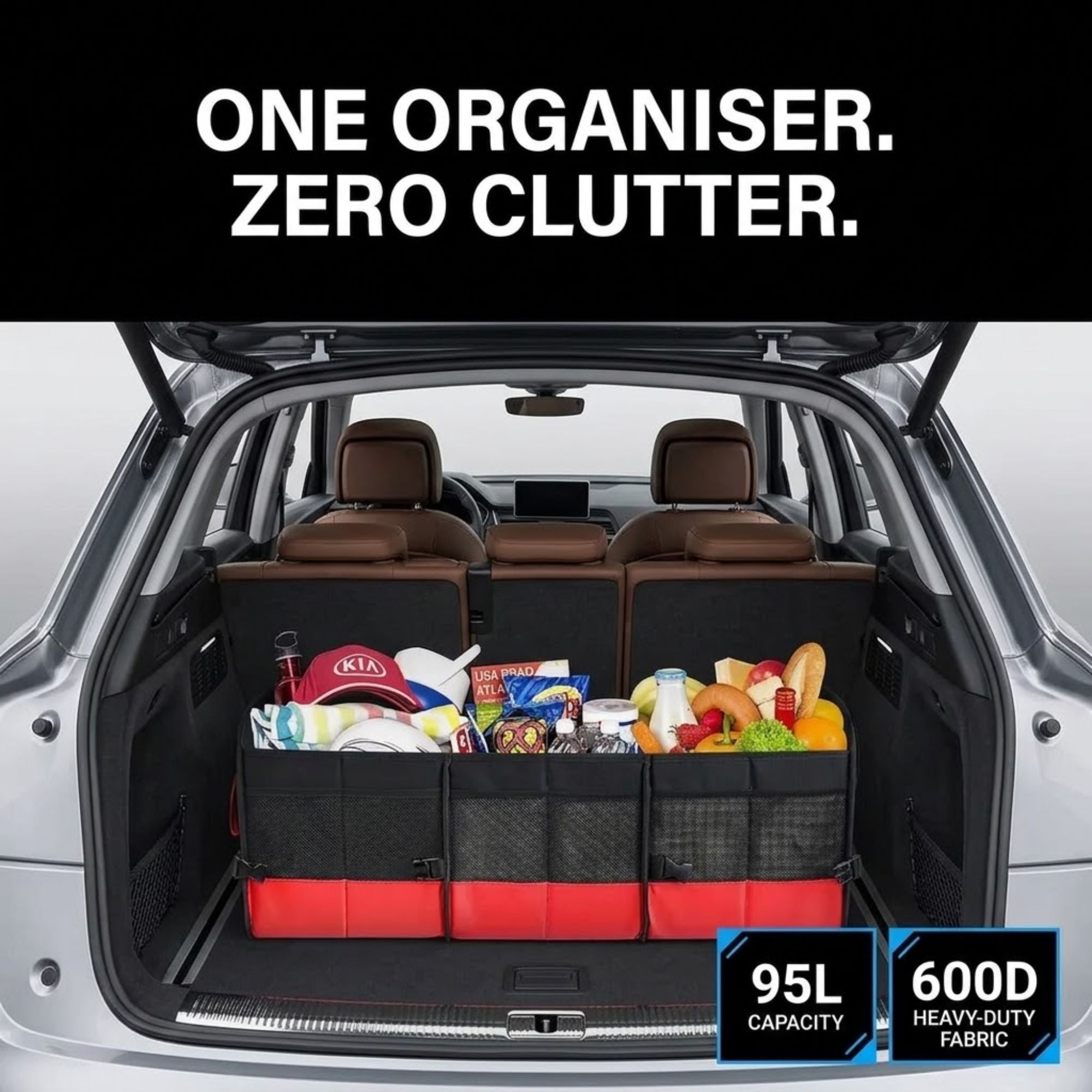A black and red car trunk organizer with mesh pockets, shown installed inside the open trunk of a silver SUV. The organizer holds groceries and is positioned in front of brown leather rear seats.