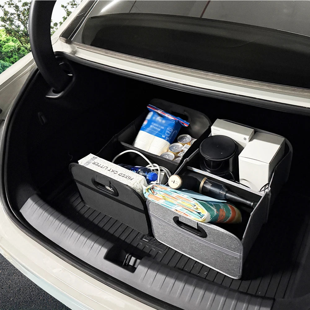 Black and grey foldable trunk organisers holding household items neatly inside a car boot