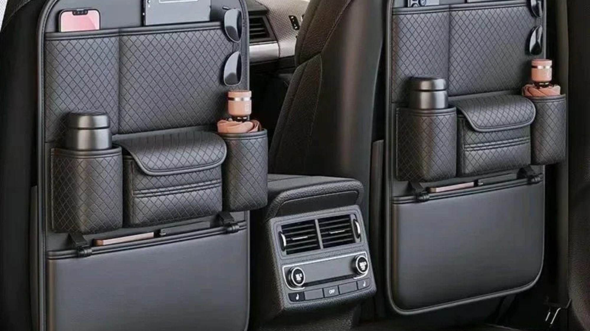 Two black car backrest storage bags mounted on the rear seats of a vehicle, shown with cup holders, phone pockets, and storage compartments. Text at the bottom reads 'Backrest Storage Bag' and 'Durable Leather • Convenient Storage • Easy Installation'.