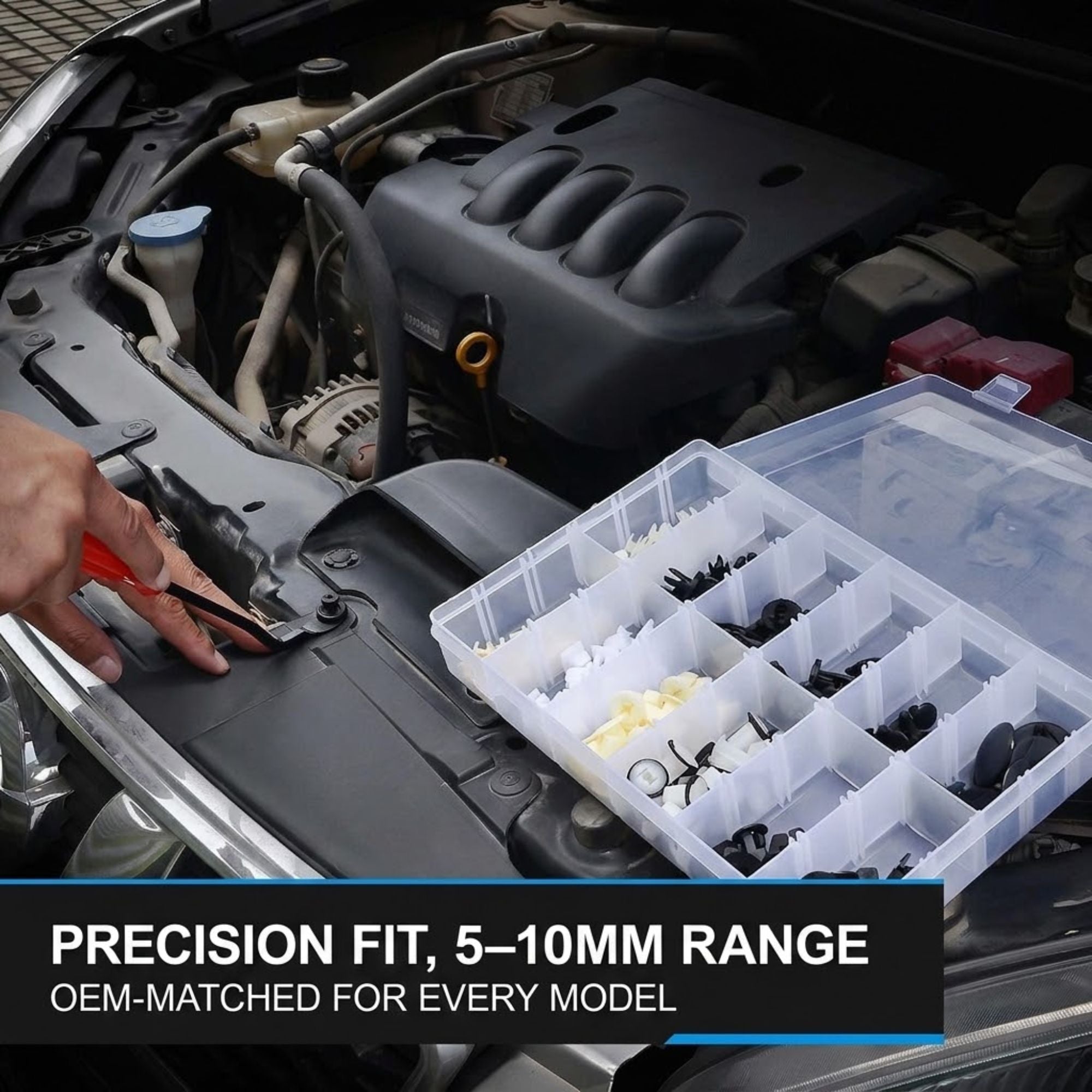 A hand using a red-handled tool to place a small black automotive fastener into a clear plastic organizer box containing various small hardware pieces. The organizer is placed on an open car engine bay, with text at the bottom reading 'PRECISION FIT, 5-10MM RANGE OEM-MATCHED FOR EVERY MODEL'.