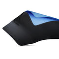 A close-up of a black textured yoga mat with a blue textured underside, shown on a clean white background.