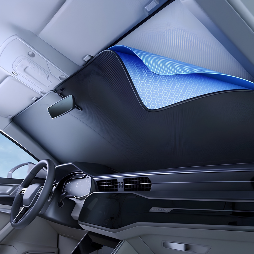 A car sunshade installed in the windshield area of a modern vehicle interior, shown partially rolled up to reveal its blue textured underside.