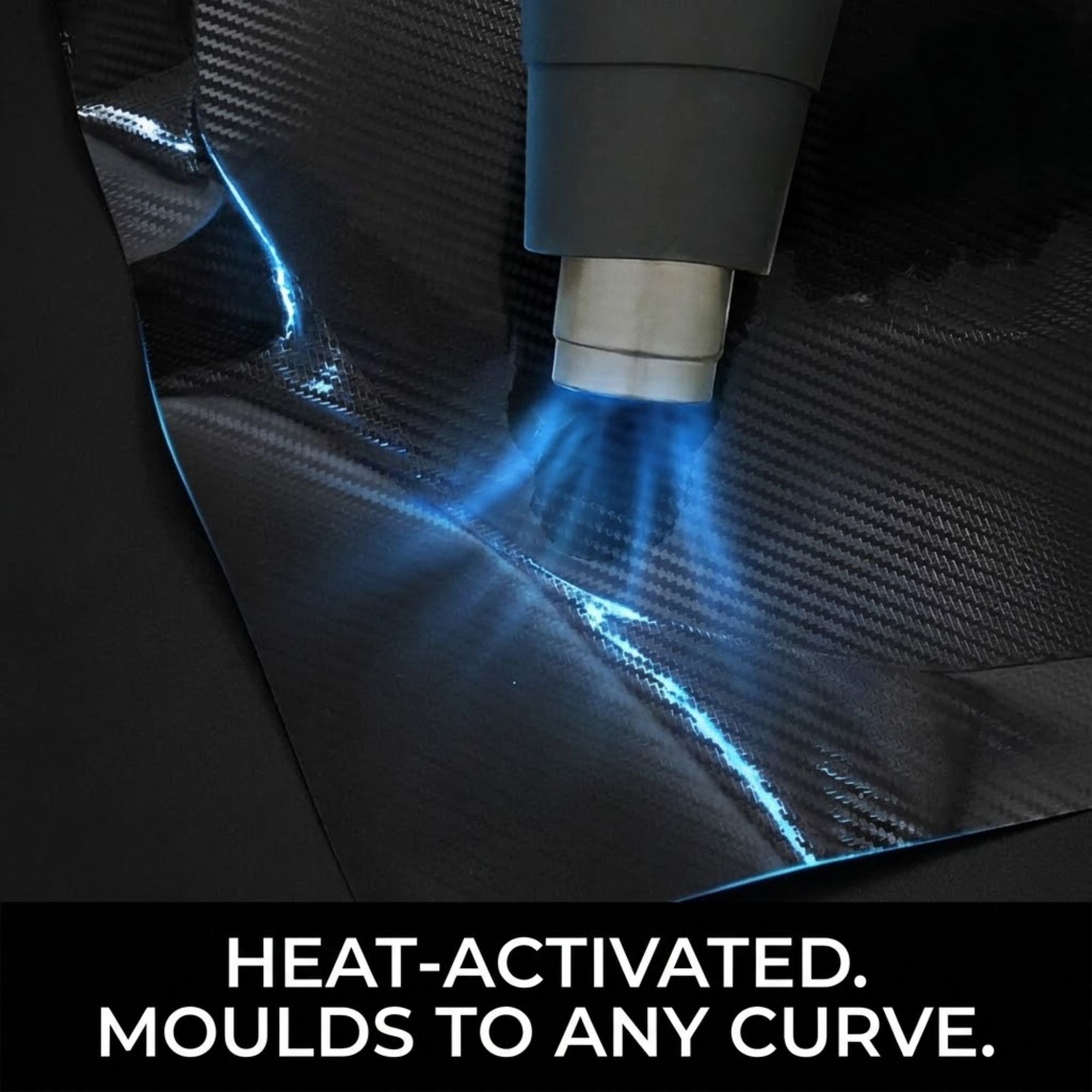 A close-up of a heat gun applying heat to a black carbon-fiber-patterned material, with bright blue light effects and the text 'HEAT-ACTIVATED. MOULDS TO ANY CURVE.