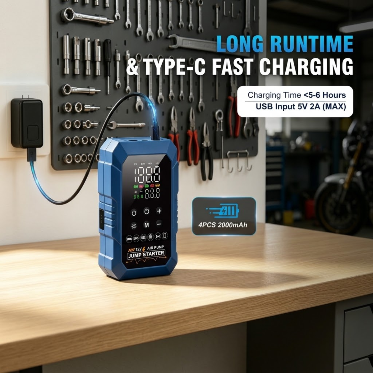 Compact Jump Starter Inflator charging via USB-C cable on a garage workbench with tool wall behind