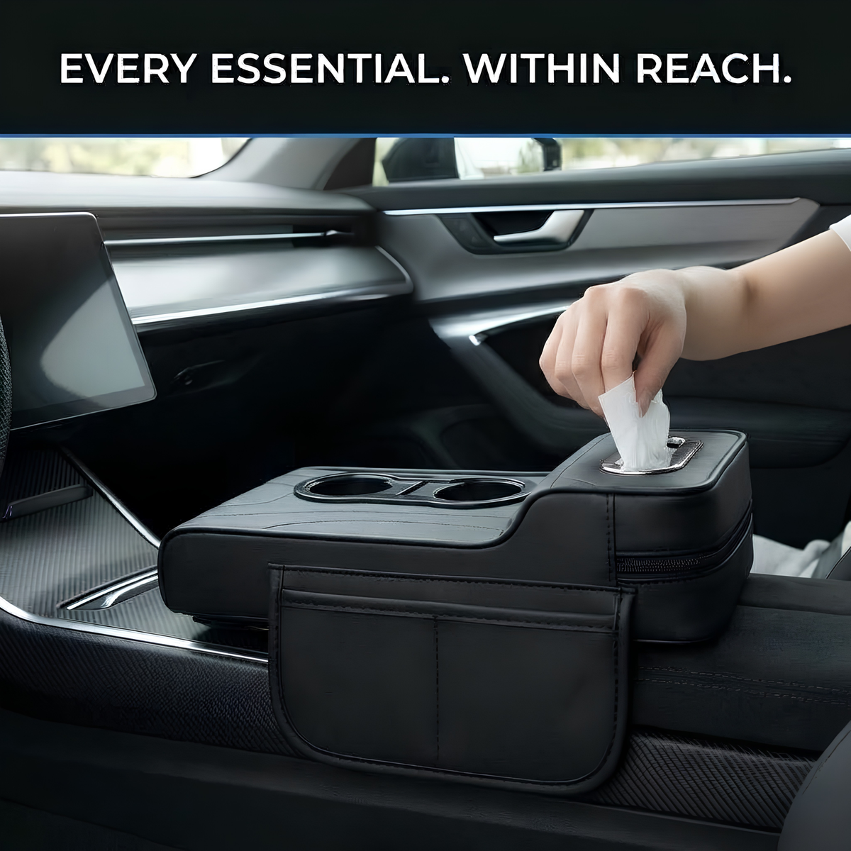 A black car center console organizer tray mounted over the armrest, shown inside a modern car interior. A hand is pulling a tissue from the top opening, and the text at the top reads 'EVERY ESSENTIAL.