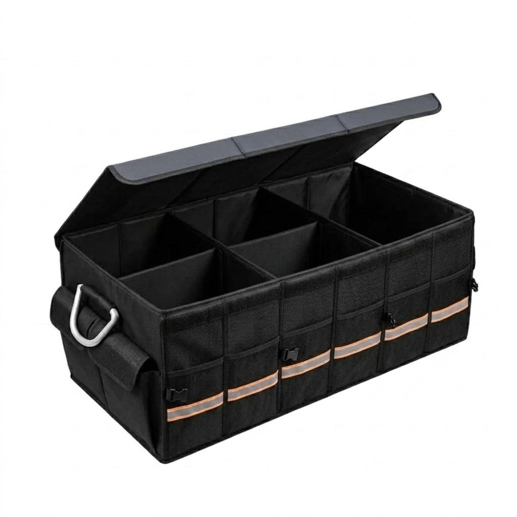 A black plastic and fabric utility organizer box with a hinged lid, shown open to reveal multiple internal compartments. The organizer features a front pocket with reflective silver stripes and a silver metal D-ring handle, set against a plain white background.