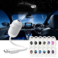 A white USB car ambient light projector shown in a car interior scene with a starry night sky projection, alongside a row of small round decorative light covers displaying different galaxy and space designs.