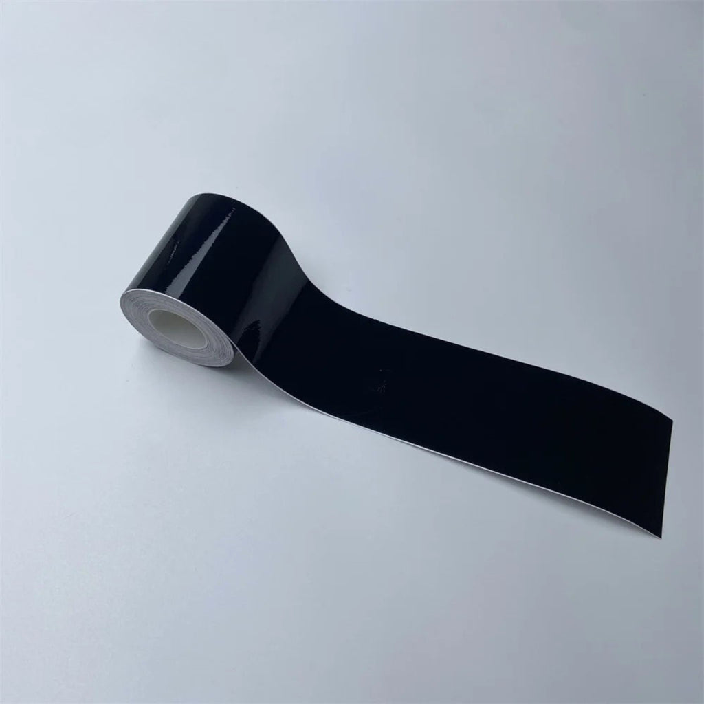 Roll of Gloss Black Trim Wrap vinyl film partially unrolled on a white background