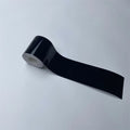 Roll of Gloss Black Trim Wrap vinyl film partially unrolled on a white background