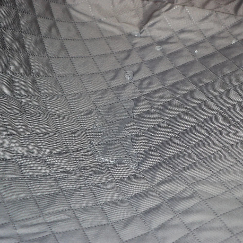 Water beading on the quilted fabric surface of the Waterproof Dog Boot Liner demonstrating waterproof protection