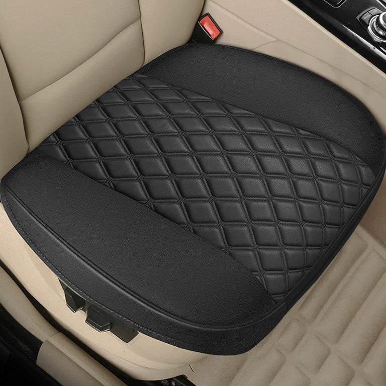 Nexura Auto black leather seat cover fitted to a car's front seat with beige interior trim.