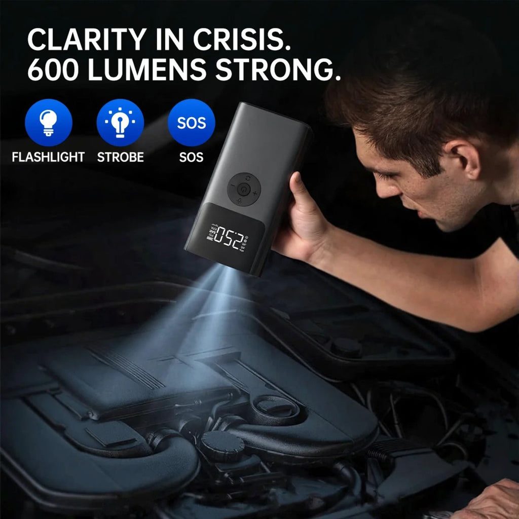 Man using the Heavy-Duty Diesel Jump Starter's 600 lumen LED flashlight to inspect a car engine bay at night