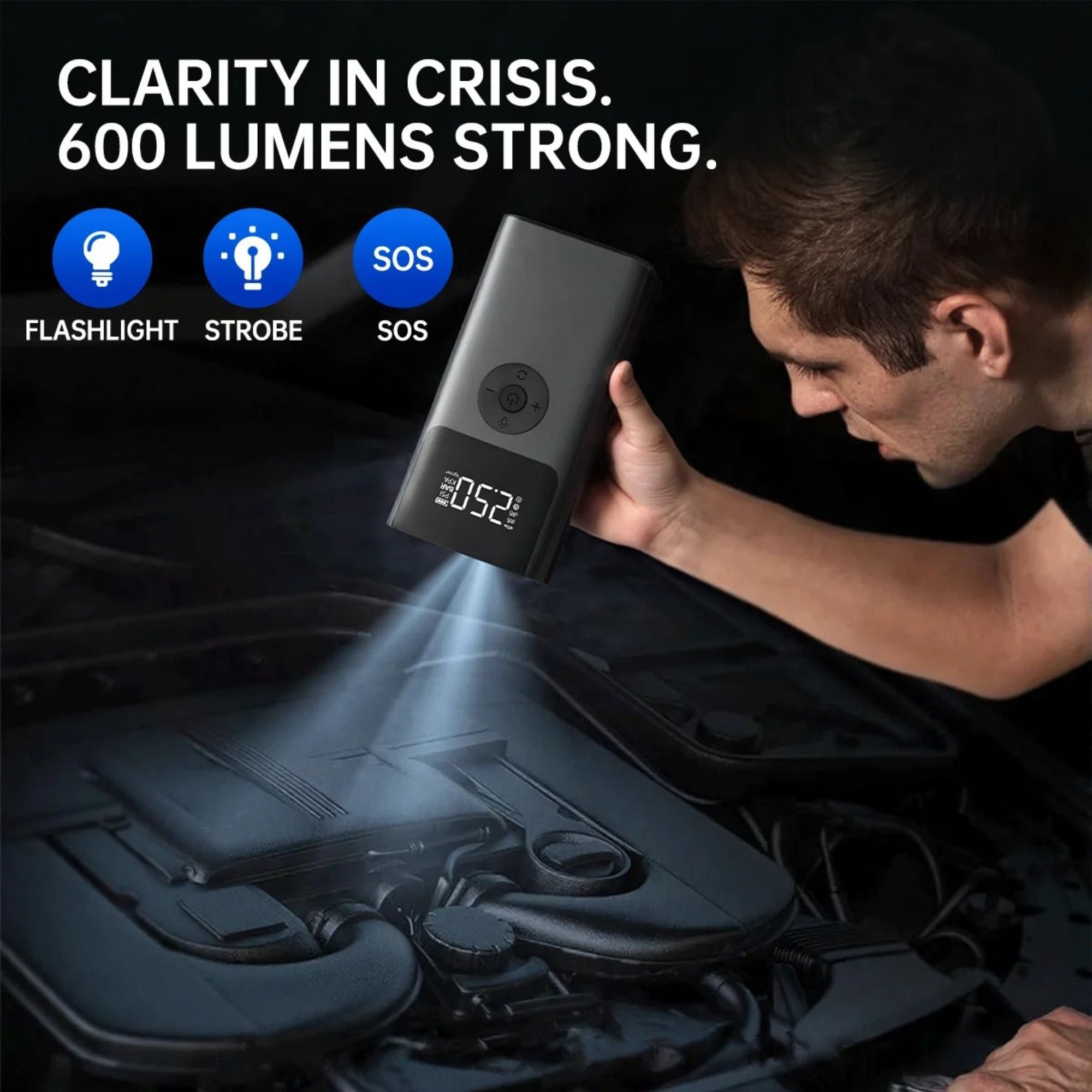 Man using the Heavy-Duty Diesel Jump Starter's 600 lumen LED flashlight to inspect a car engine bay at night