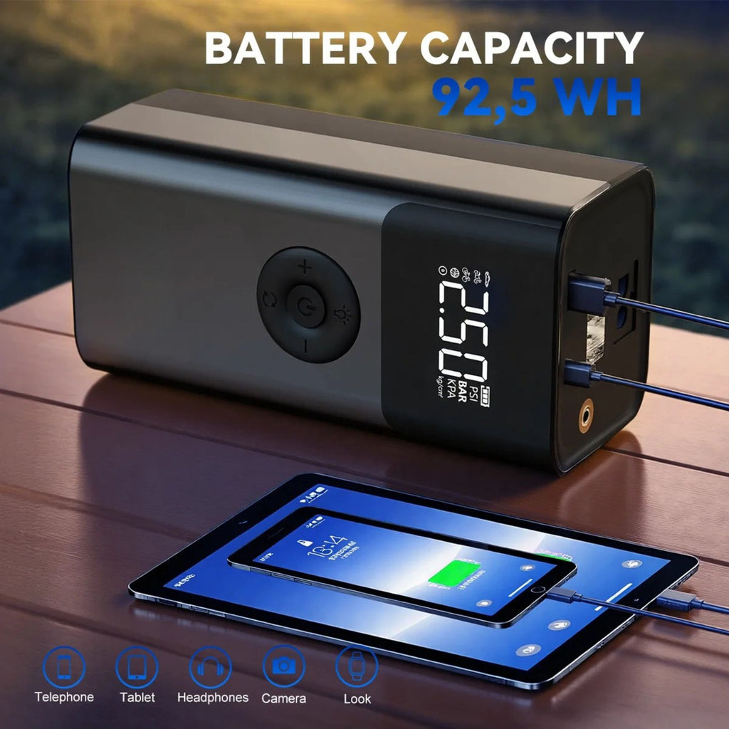 Heavy-Duty Diesel Jump Starter charging a tablet and smartphone on a wooden table, showing its 92.5Wh battery capacity
