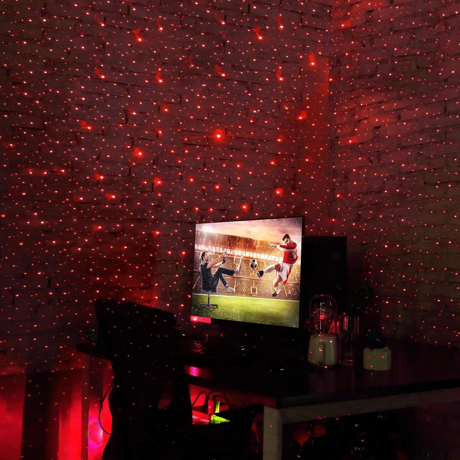 Tri-Colour Star Projector red starlight illuminating gaming room wall and desk setup