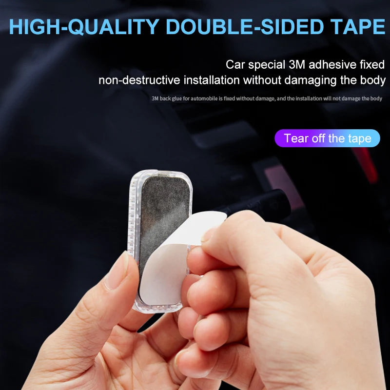 Hand tearing off the double-sided 3M adhesive backing from an LED touch light for non-destructive car installation