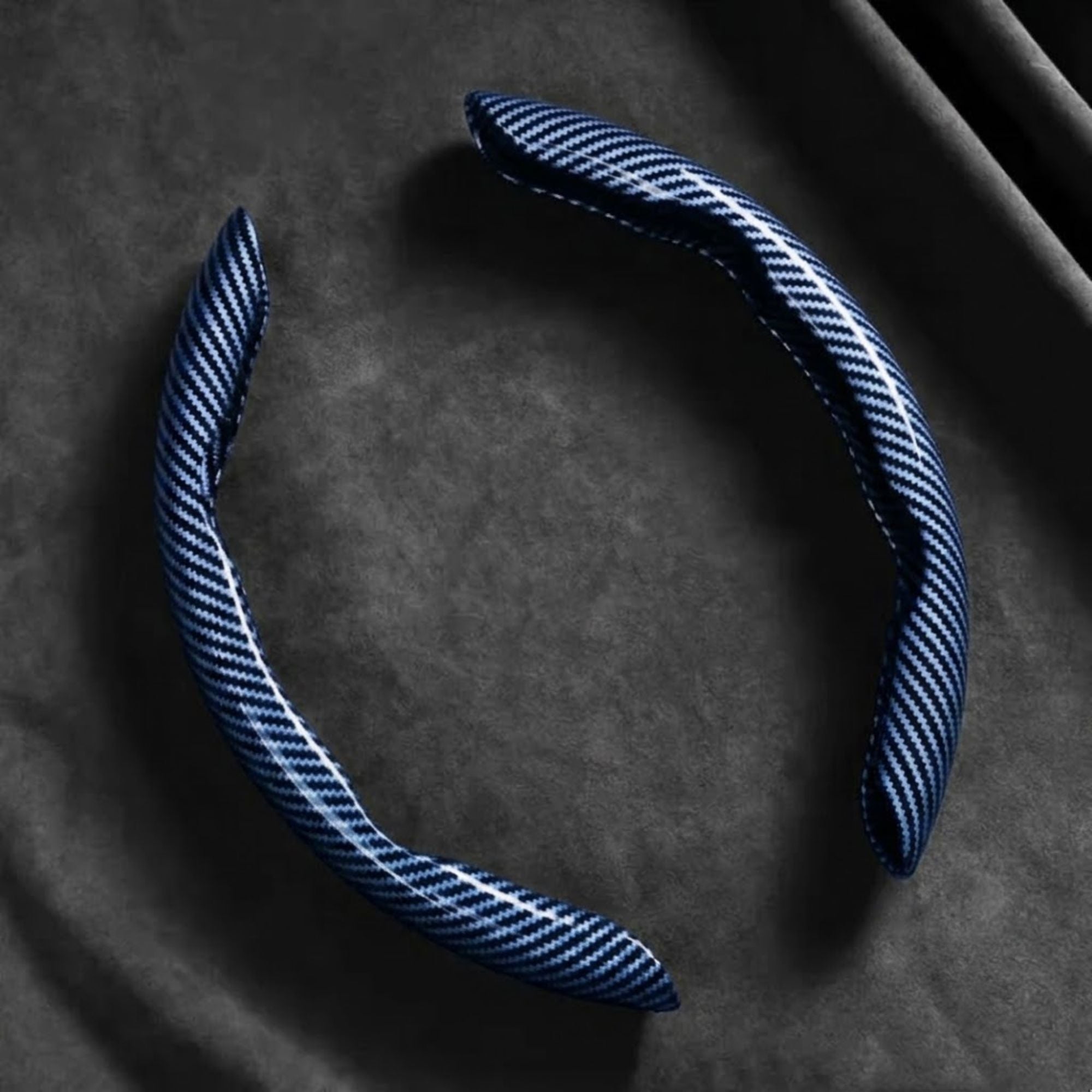 Blue Carbon Fibre Wheel Cover unclipped ring on dark background