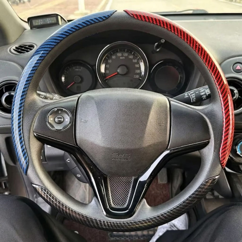 Carbon Fibre Wheel Cover in blue and red fitted on car steering wheel