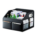 Black leather car boot organiser fully packed with drink bottles and household items in a vehicle trunk