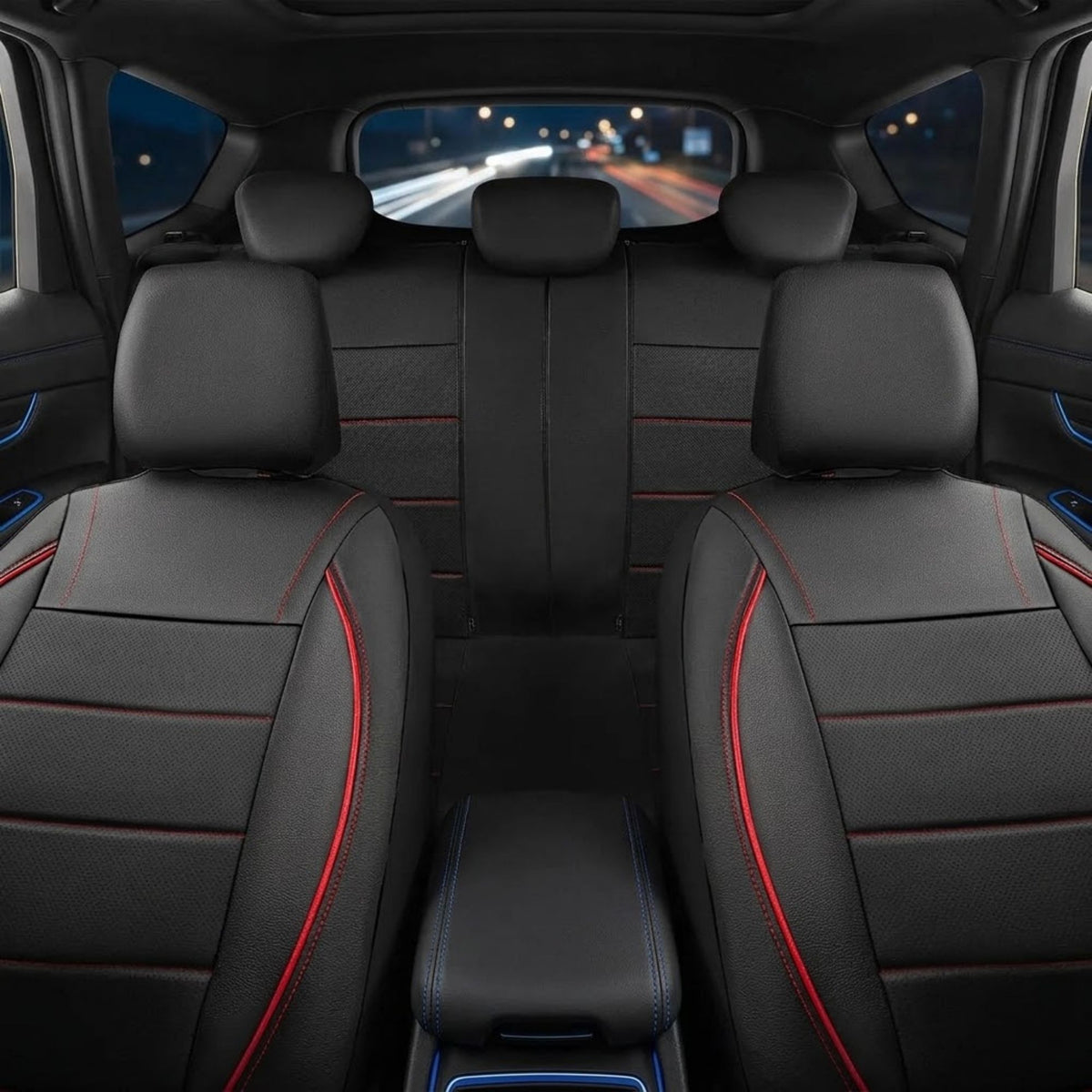 Black car seat covers with red contrast stitching installed on the front and rear seats of a vehicle interior, viewed from the back seat looking forward.