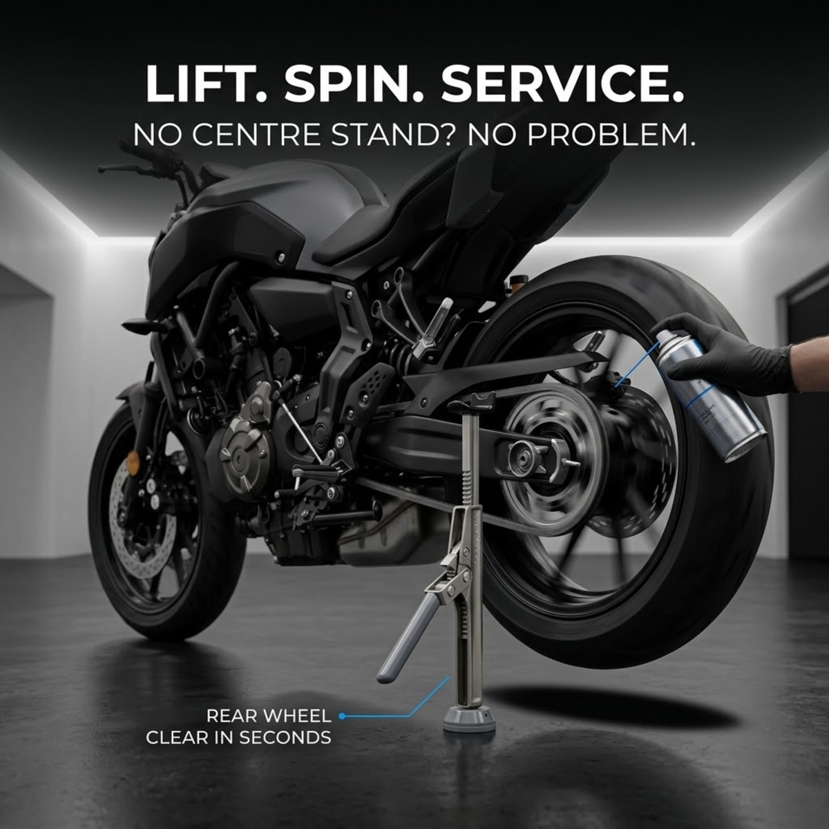 Motorcycle Ratchet Lift Stand raising the rear wheel of a black motorcycle in a garage while the chain is sprayed with lubricant