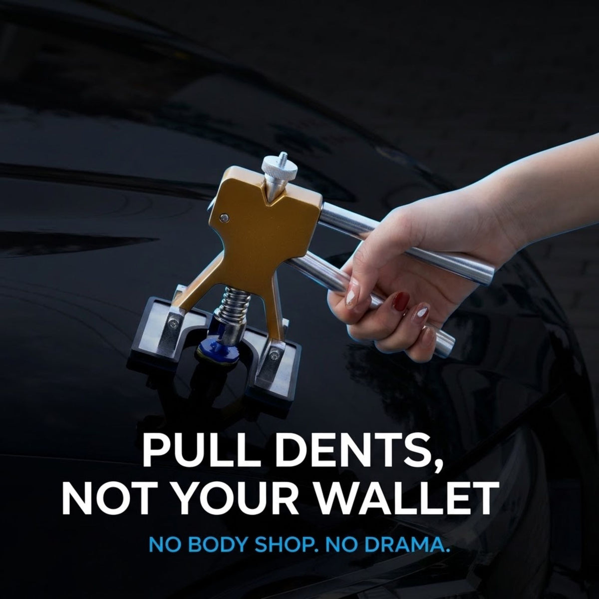 A hand holds a metallic dent pull tool against a black car door, with text reading 'PULL DENTS, NOT YOUR WALLET' and 'NO BODY SHOP. NO DRAMA.