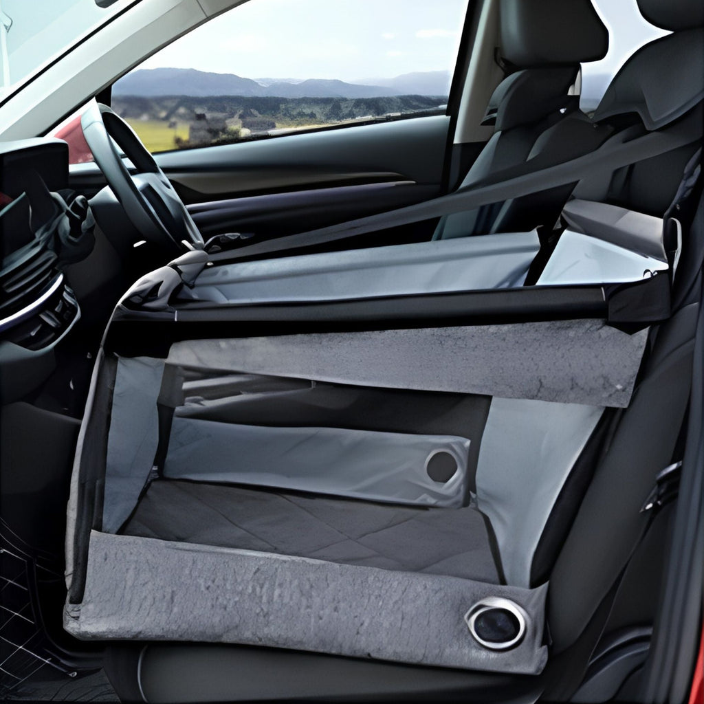 Empty grey portable pet car seat installed on a car front passenger seat with seatbelt threaded through