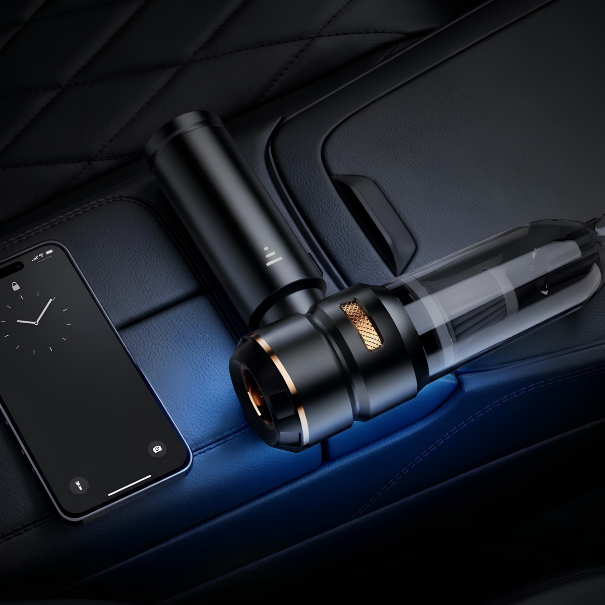 A sleek black and transparent car air freshener diffuser with a gold accent ring, resting on a dark quilted leather car seat next to a smartphone displaying its app interface.