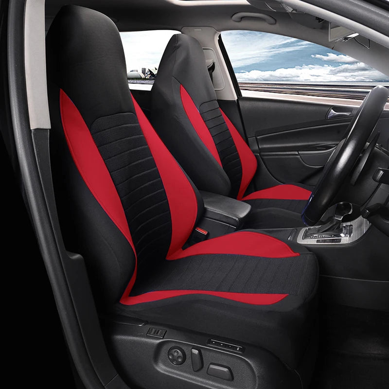 Black and red front bucket seat cover installed in a car, angled view of the dashboard and steering wheel