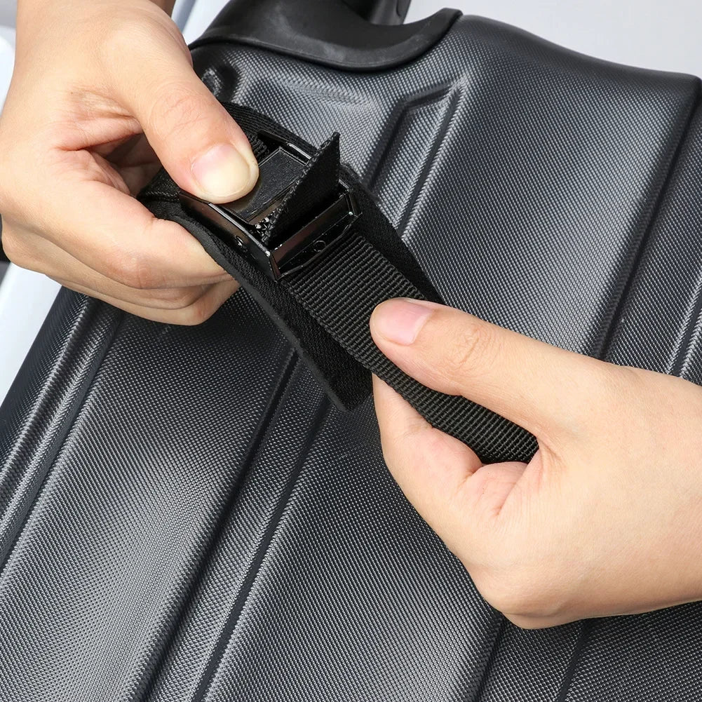 Close-up of hands tightening the Foldable Roof Rack's buckle strap onto a car roof