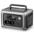 600W LiFePO4 Power Station in grey with carry handle, LCD display, two AC outlets, USB ports and built-in LED light on a white background