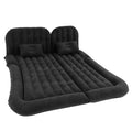 Black flocked back-seat car air mattress with inflatable headboard and two pillows on a white background