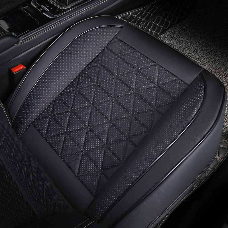 Front Seat Cushion Cover in black fitted to a car seat, close-up angled view