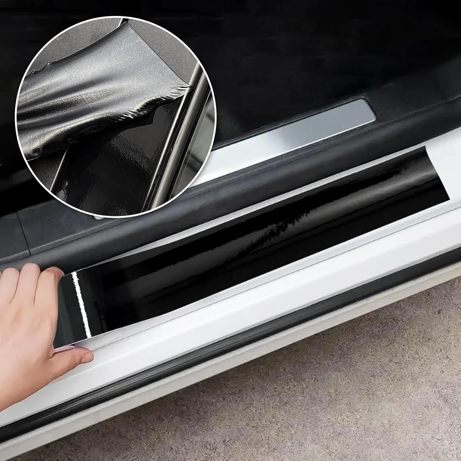 Hand applying Gloss Black Trim Wrap to a car's door sill scuff plate with adhesive backing peeled back