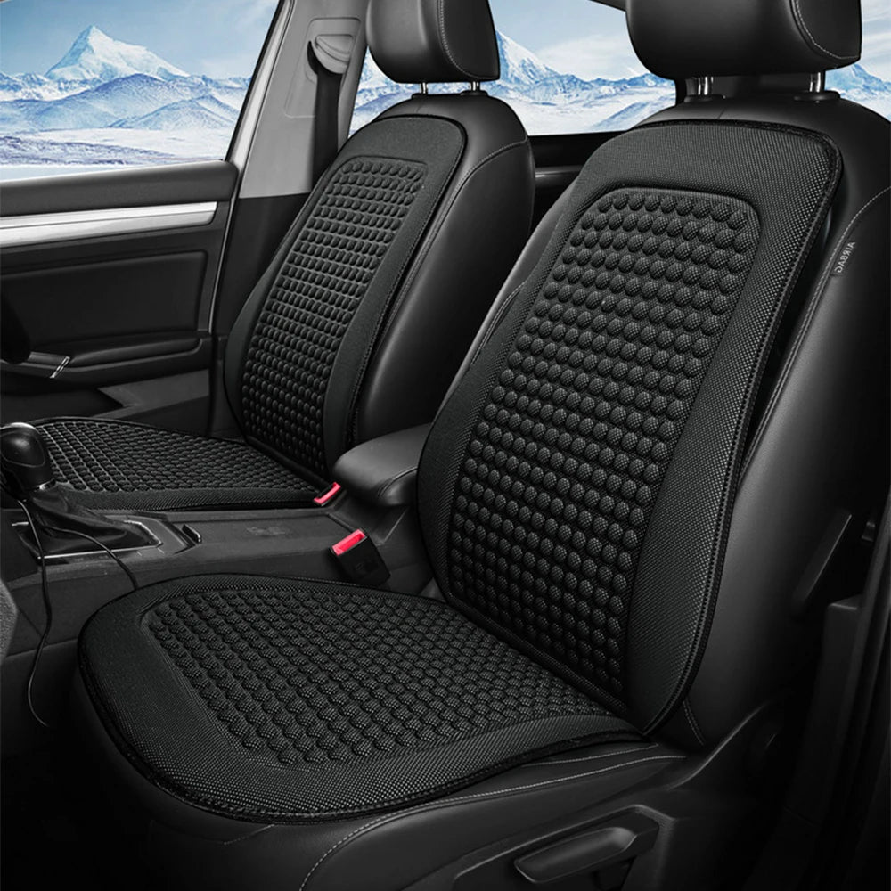 Ice-Silk Seat Cushion fitted to both front seats of a car with a snowy mountain view through the windows