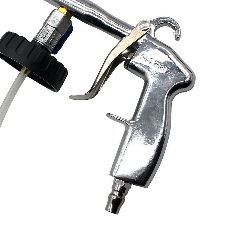 Close-up of the pneumatic detail cleaning gun's chrome trigger and air inlet mechanism