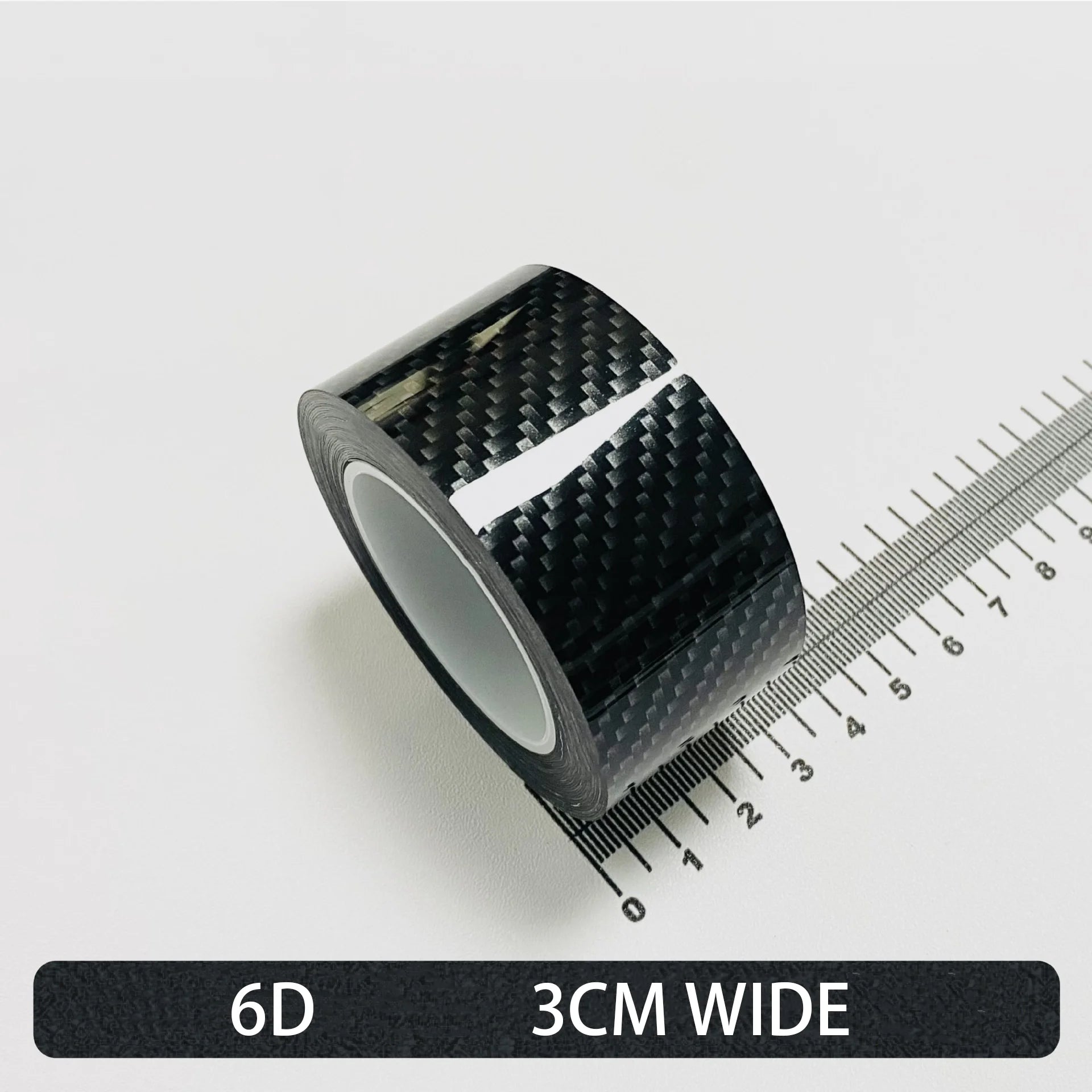 Roll of High-Gloss 6D carbon fibre wrap tape, 3cm wide, shown on a white background with a ruler for scale.