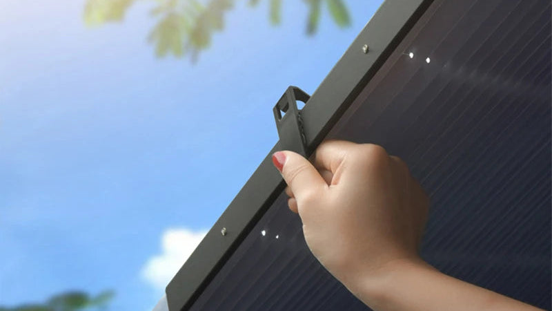 Hand adjusting a Retractable Windscreen Sunshade.