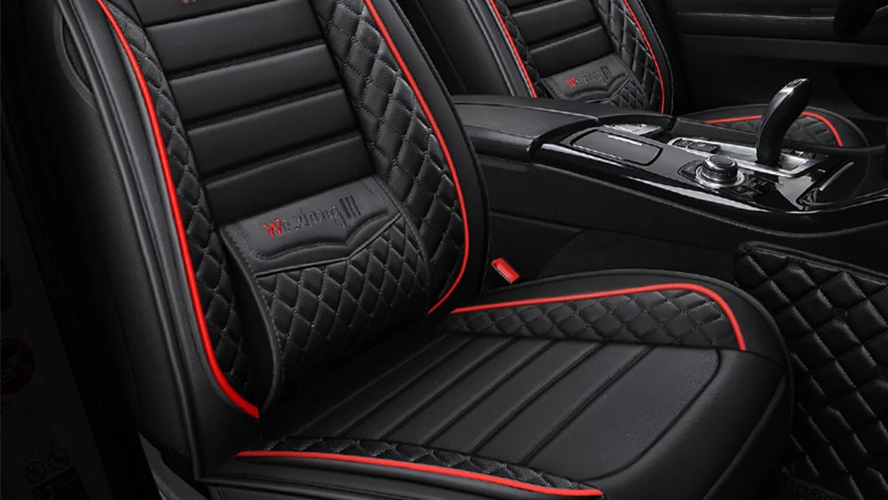 Black and red quilted car seat covers with a visible brand logo in a car interior.