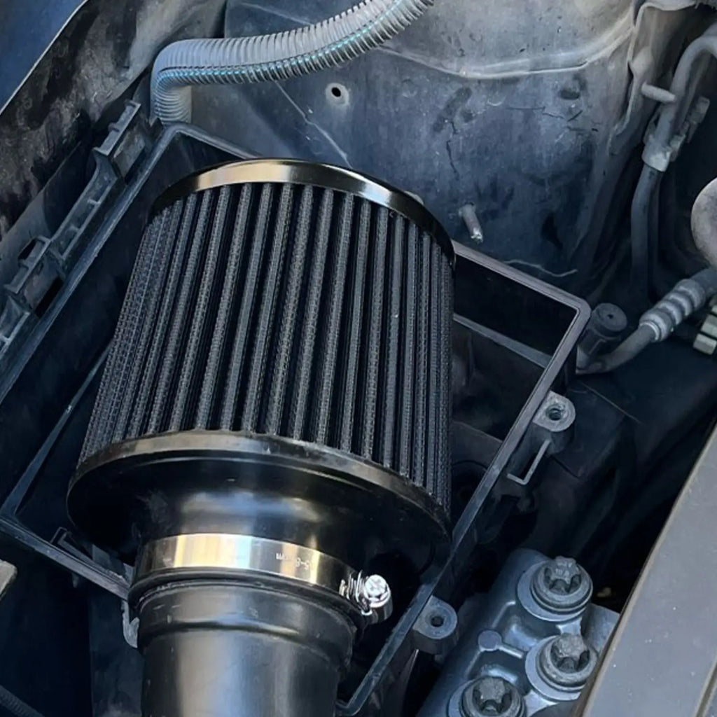 Cold air intake performance air filter installed in a car engine bay