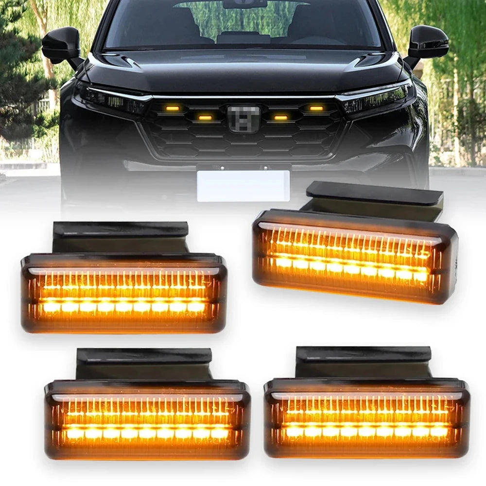 Set of four Smoked Amber Grille Lights glowing amber, shown fitted to the front grille of a black SUV