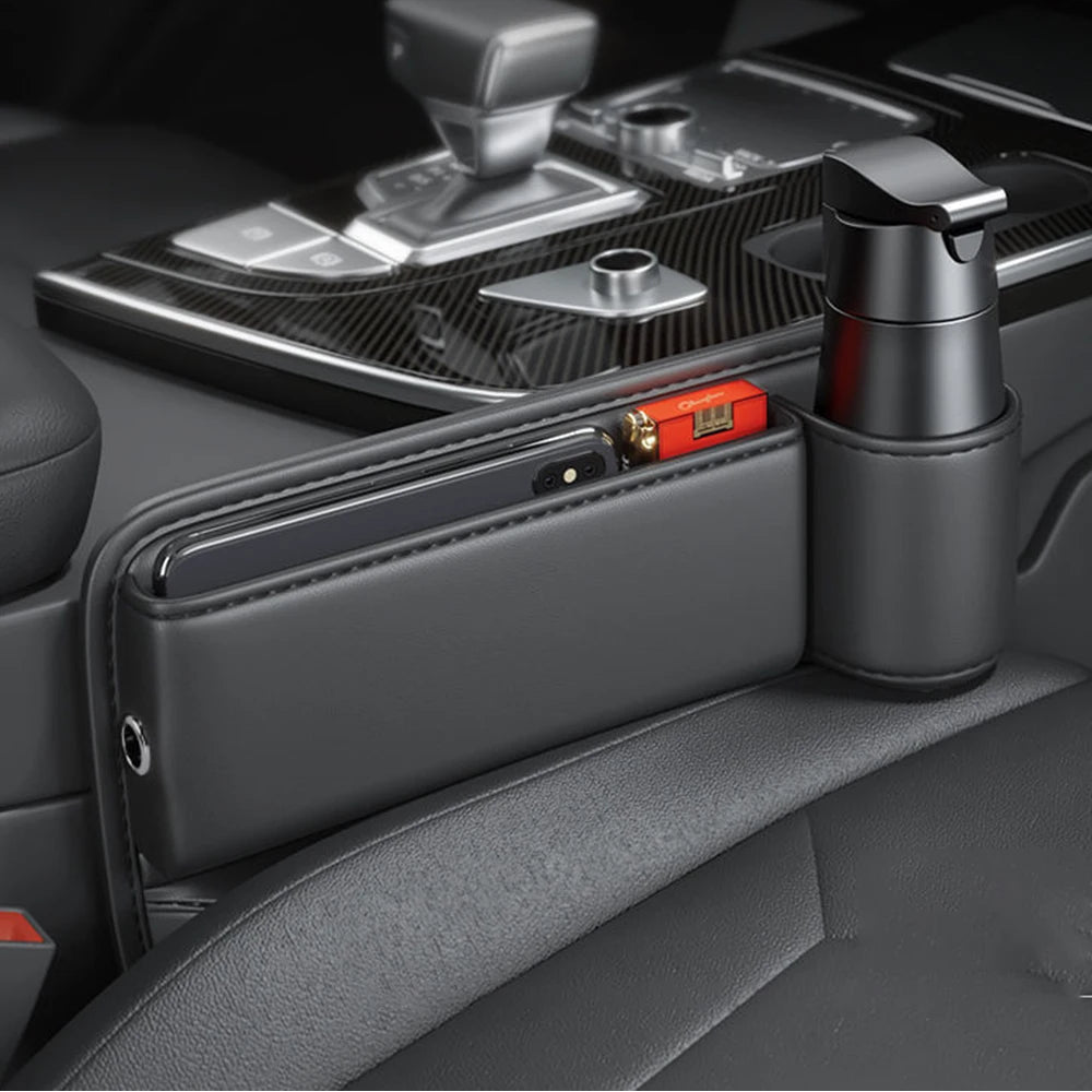 Leather seat gap organiser fitted in the centre console of a car, shown alongside the gear shifter and cup holder for scale.