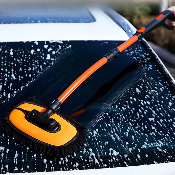 Chenille Car Wash Mop being used to scrub soap suds off a car roof at night