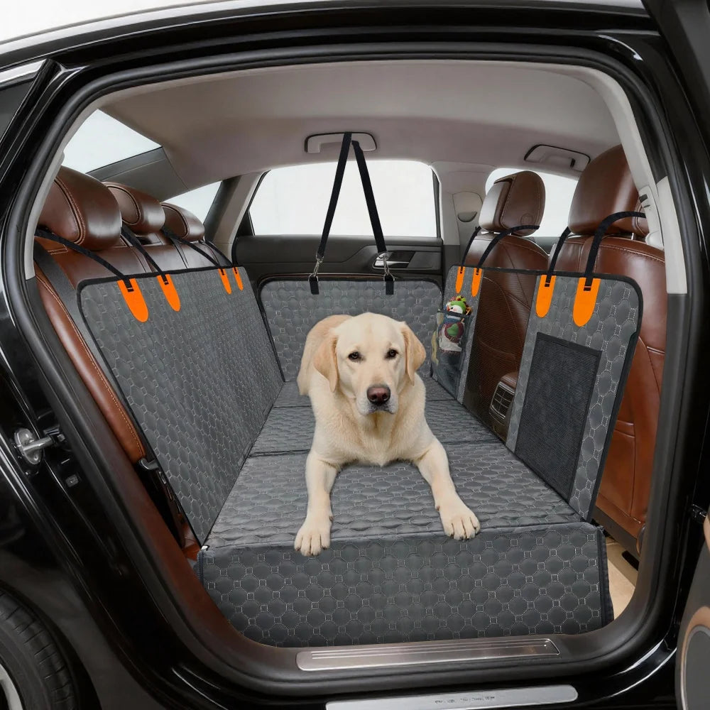 Labrador lying on the Washable Dog Seat Extender installed across a car back seat with side flaps and mesh window