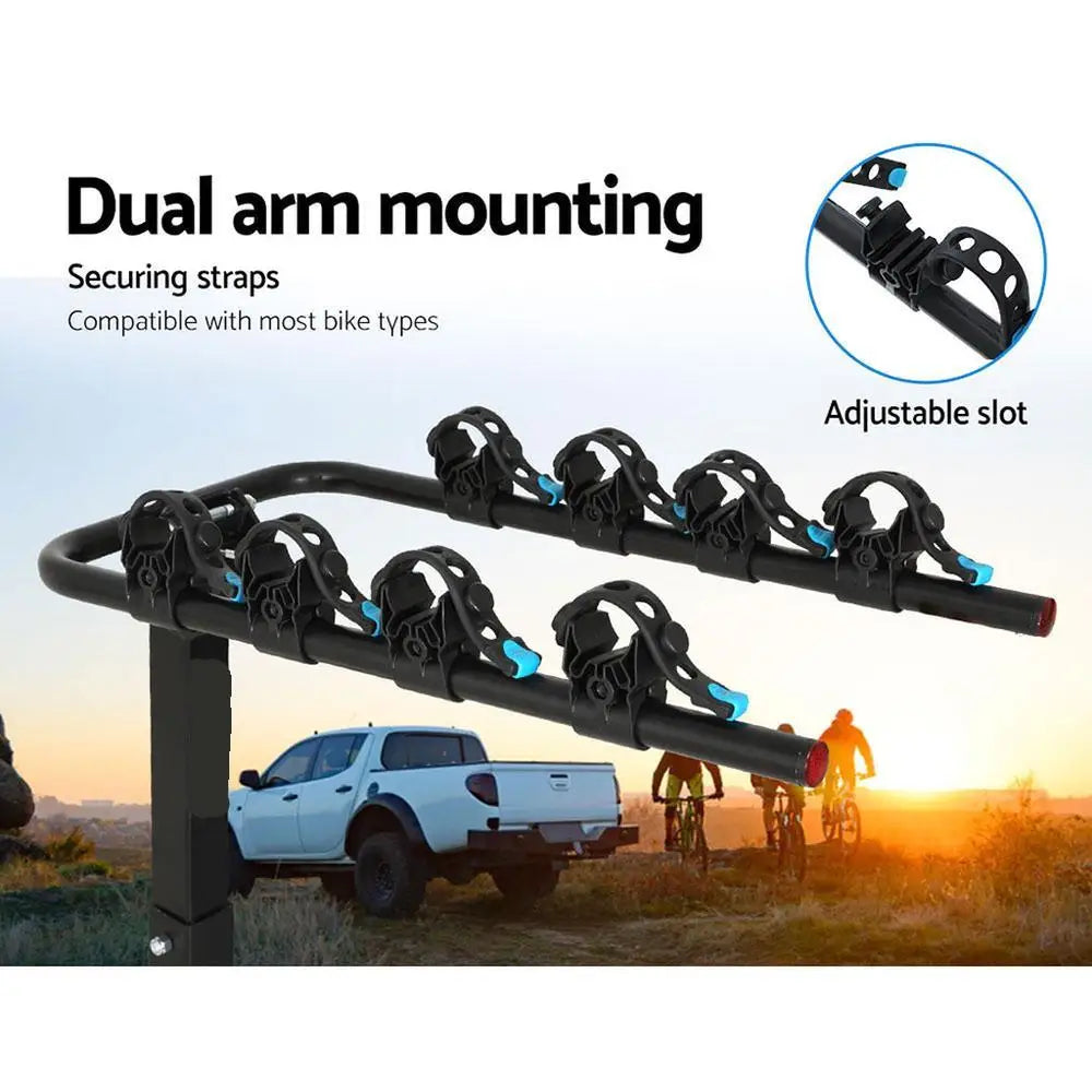 Foldable 4-Bike Hitch Rack dual arm mounting with securing straps and adjustable slots, with cyclists and a ute at sunset