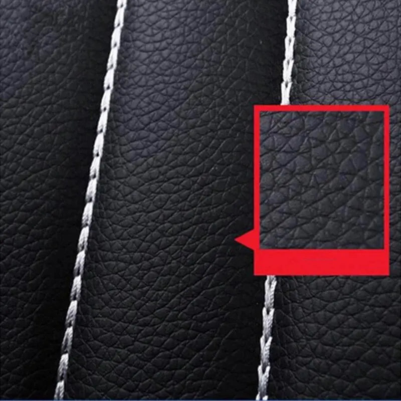 Extreme close-up of black leather seat cover stitching with red callout box highlighting texture detail on Universal Seat Cover Set