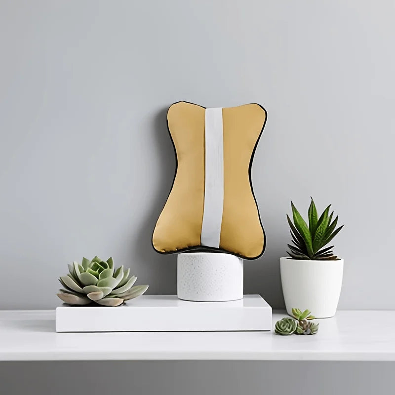 Premium car neck support cushion displayed on a shelf with succulent plants