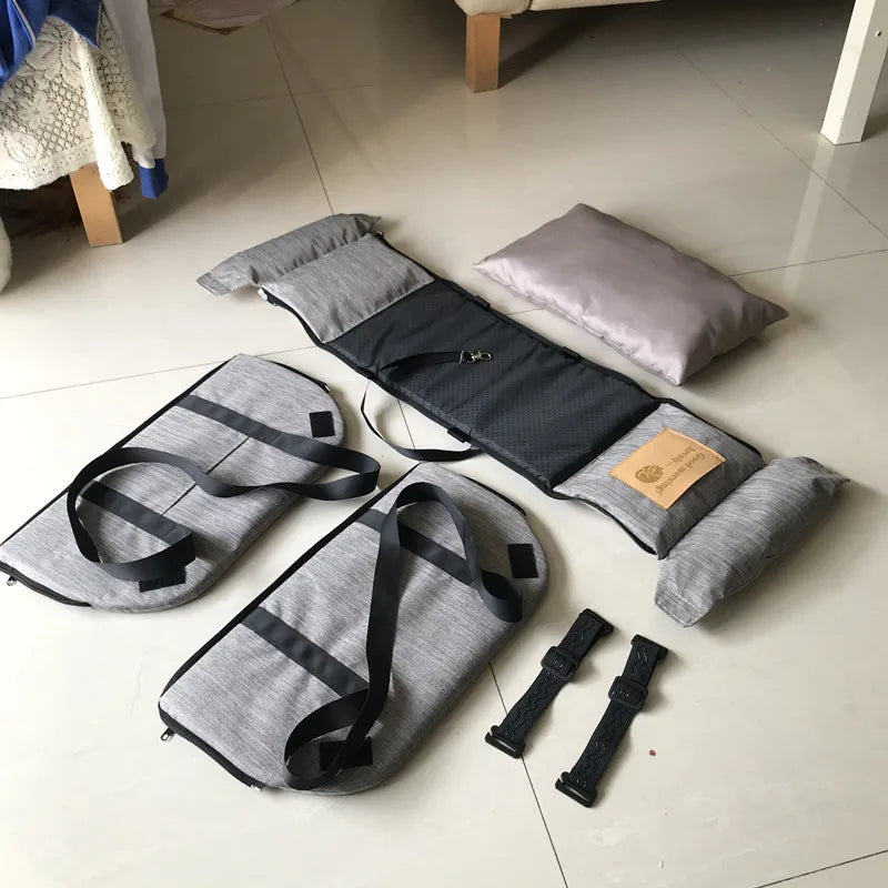 Full set of console pet booster seat components laid out flat, including folded seat, cushions and straps