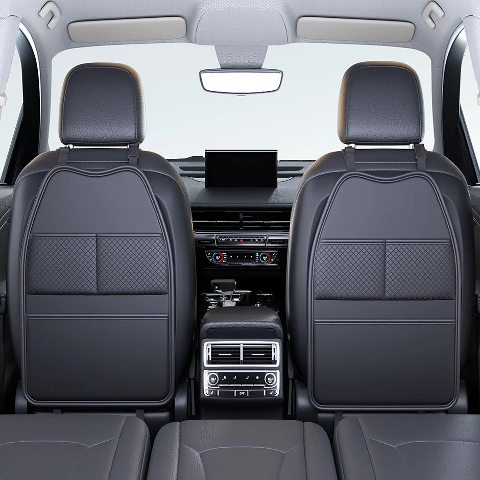 Two black kick-proof seat back organisers installed on the front seats of a car, viewed from the back seat
